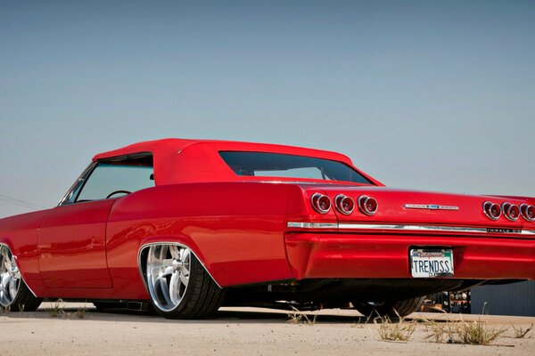 Red chevrolet impala on the street