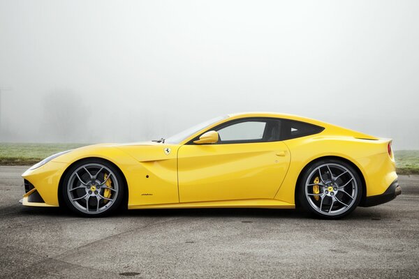 Yellow beauty ferrari in the fog