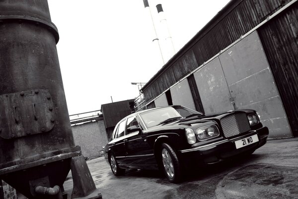 Black Luxury Car Next to garages