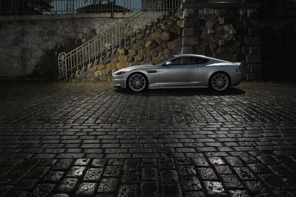 A gray car on a rocky platform