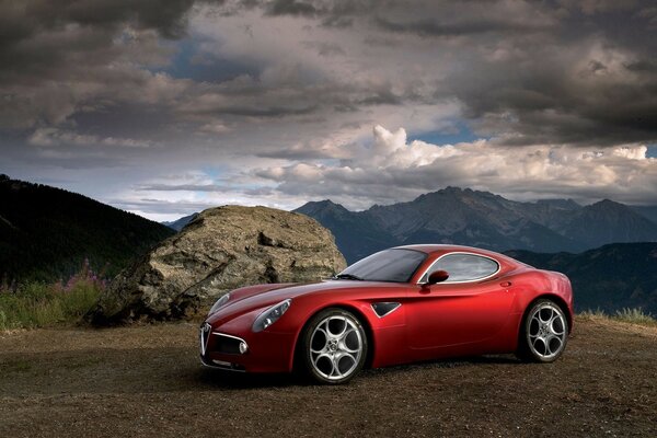 Cool red car on the road clouds and mountain view