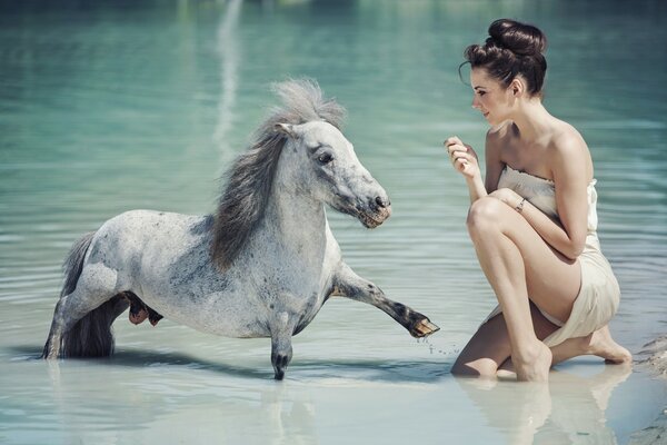 Fille et poney dans l eau