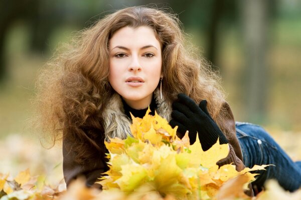 Photo of a girl with autumn leaves