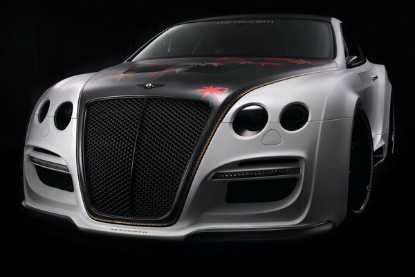 A tuned Bentley on a black background