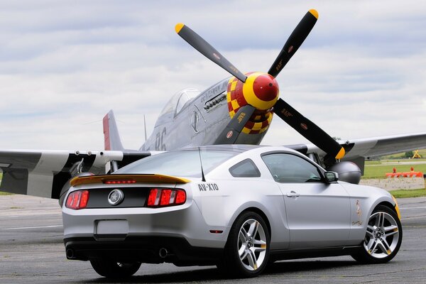 A car passes near the propeller of a helicopter