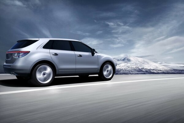 Saab 9-4x drives a mountain road at high speed