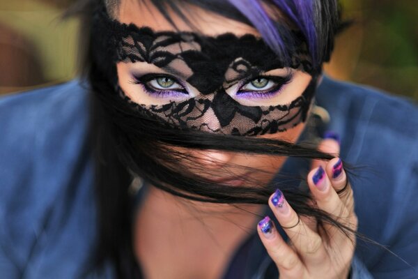 Beautiful girl in a black mask