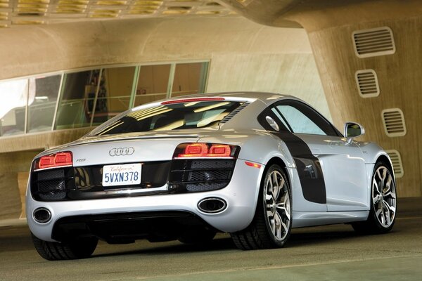 Gray Audi r8 slowed down near a futuristic building