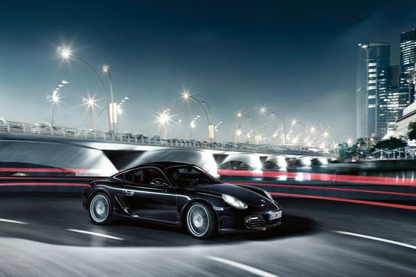 Porsche negro en el fondo de la ciudad de la noche