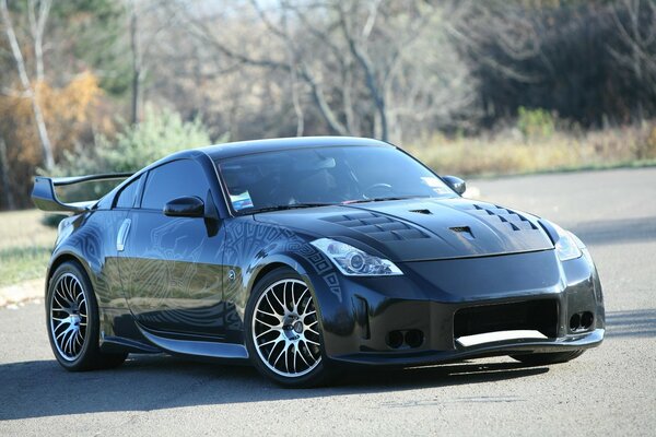 On the highway - a blue-black tuned Nissan with low clearance