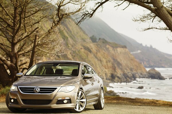 Volkswagen on the coast against the backdrop of mountains