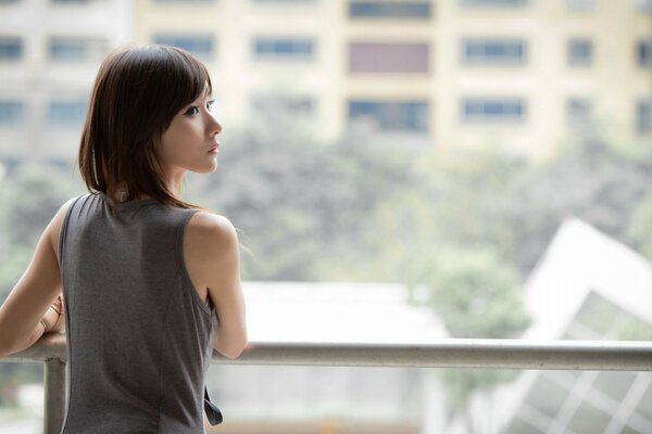 Fragile Asian girl on the balcony