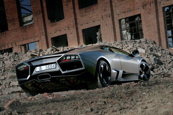 Lamborghini reventon black stands against the ruins