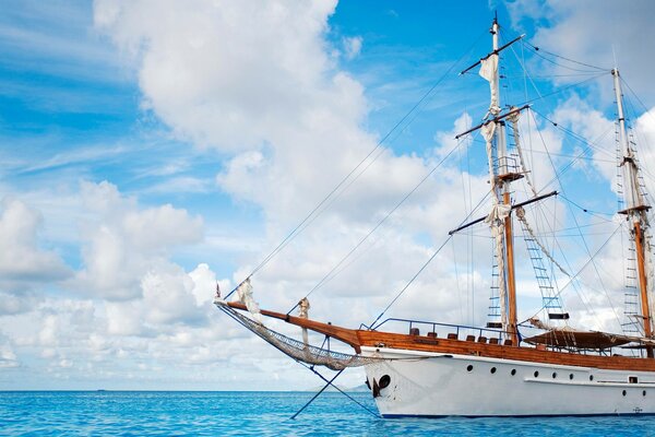 Sailboat in the open sea and cloudy sky