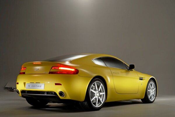 Yellow Aston Martin on display in the salon