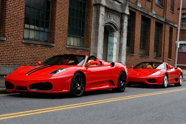 Red Ferraris on the background of a brick building