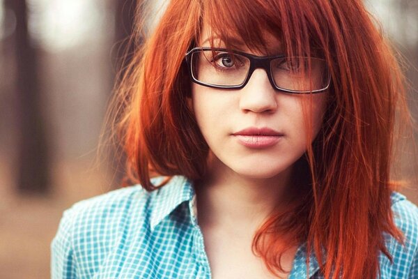 Red-haired disheveled girl with glasses