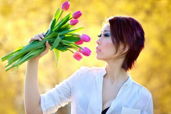 Bruna dai capelli corti con un mazzo di tulipani