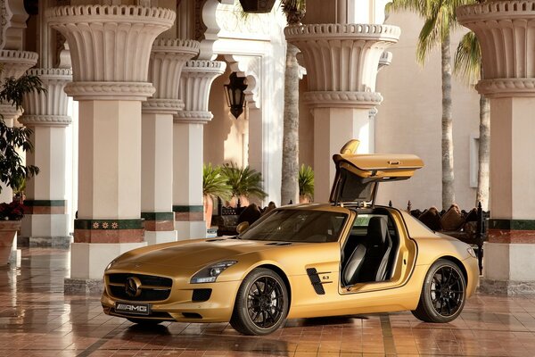 Mercedes amg sls63 dorata in sala con colonne