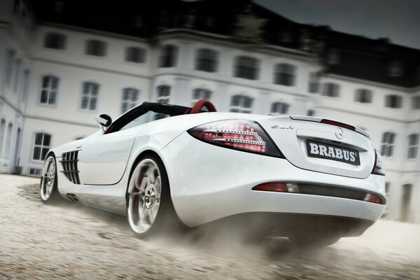 White Mercedes McLaren convertible at speed