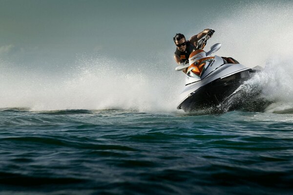 A man on a jet ski rushes through the water