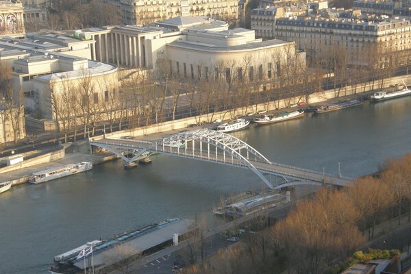 A bridge over a river in a city with white buildings