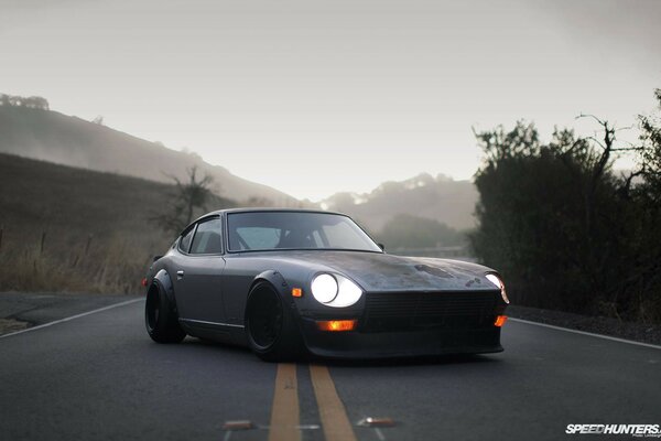 Grey car on the road in fog