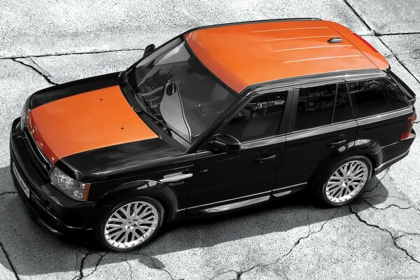 Black range rover sport with orange roof