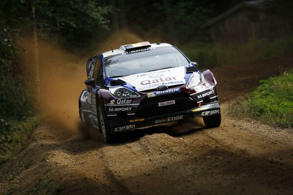 Racing Ford rushes along a dirt road 