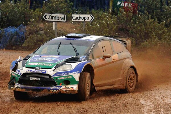 Ford fiesta wrc in cloudy weather participating in a dirty race