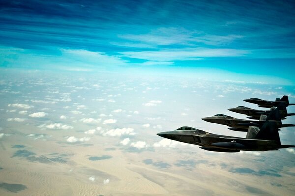 Fighter planes in flight above the clouds