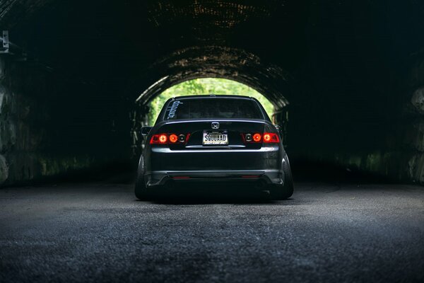 The car standing in the dark arch of the house