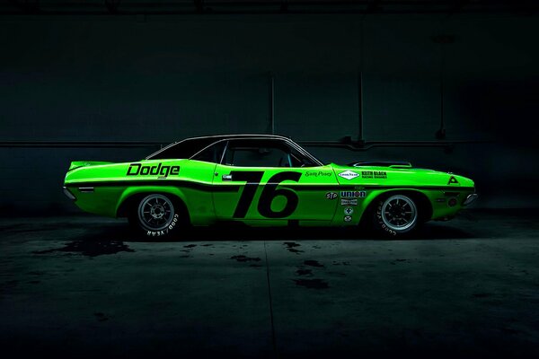 Green racing car on dark background