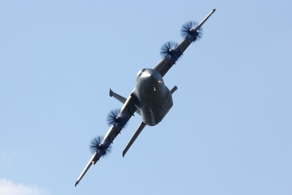 A military transport plane is flying in the sky