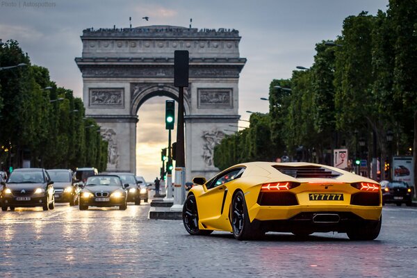 Coche Lamborghini amarillo en medio de una carretera concurrida