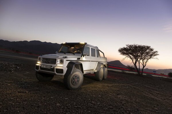 Mercedes Benz SUV in the mountains at sunset