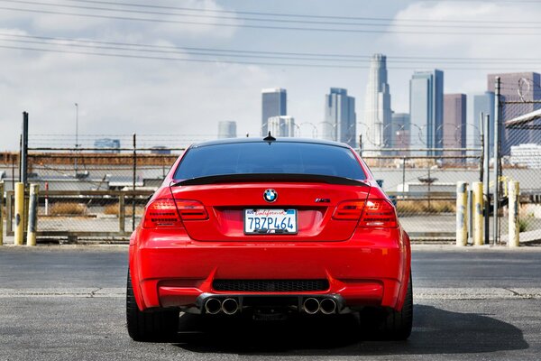 Una bmw rossa guida per la città. Grattacieli