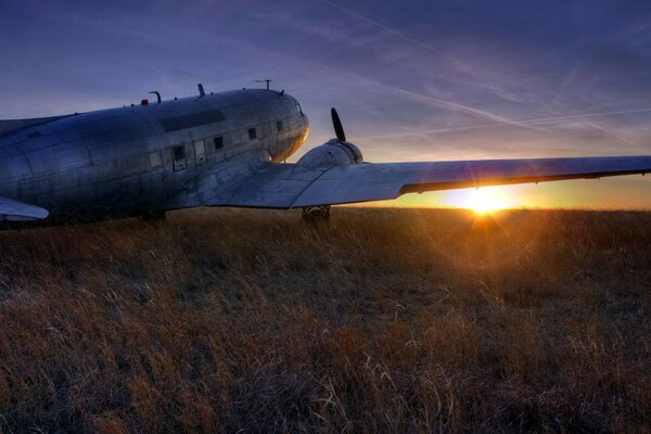 The plane is preparing to take off at sunset