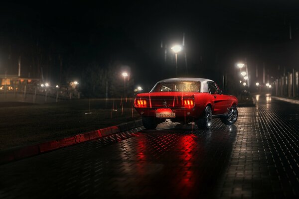 Red Ford Mustang on the river embankment