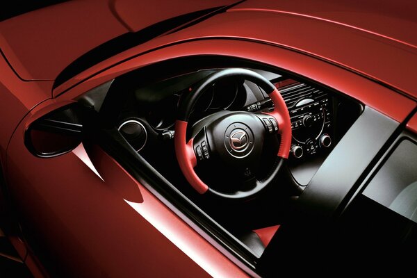 Red Mazda, steering wheel, interior through the driver s window