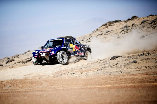 Blue buggy rides through the desert