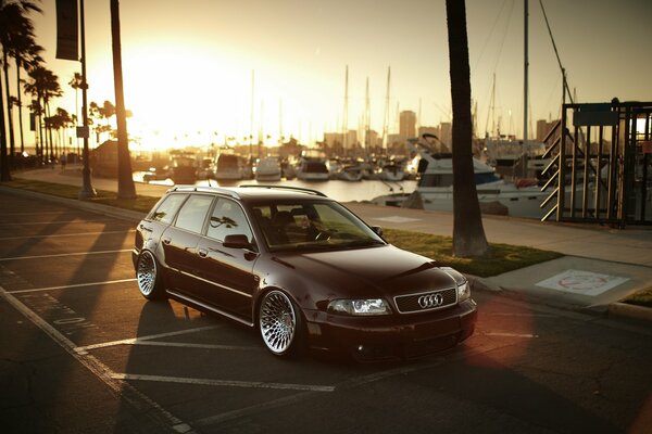 The brown station wagon is at sunset