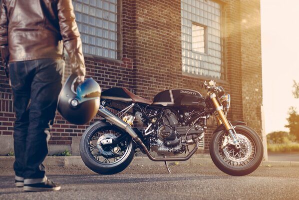 Motorcyclist admires the black ducatti