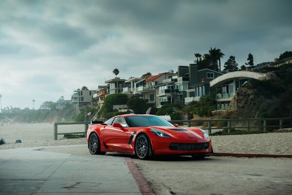 Red chervil corvette near houses