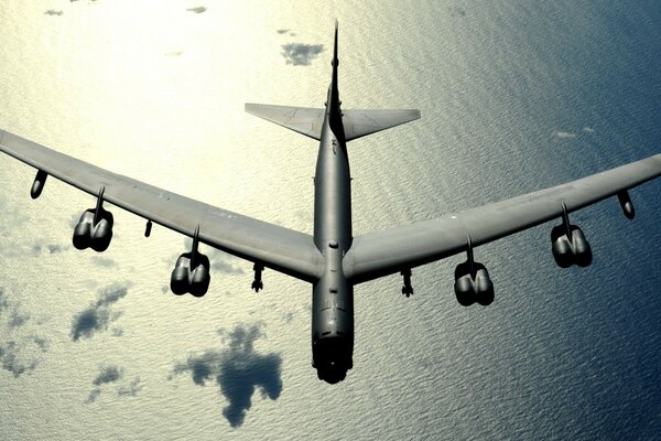 An aircraft flies over the ocean