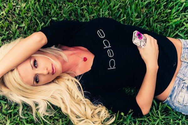 Blonde in a black sweater on the grass