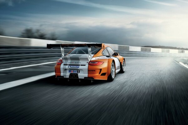 Racing on the track in a Porsche sports car