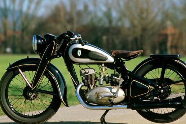 Old retro motorcycle on a background of green grass