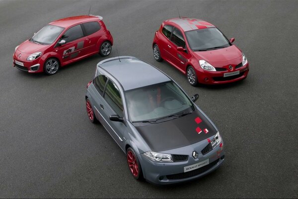 3 renault megane cars are on the asphalt