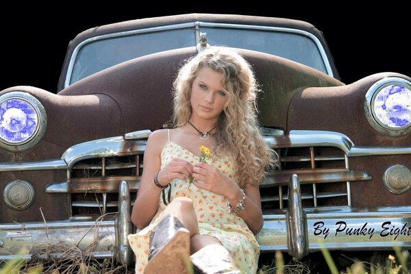 A girl with a flower on the background of a car